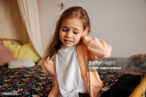 little girl having an earache - infectious disease stock pictures, royalty-free photos & images