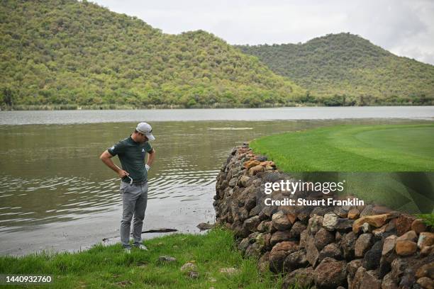 Guido Miglizzi of Italy ponders his approach shot on the 17th hole during the weather delayed second round during Day Three of the Nedbank Golf...