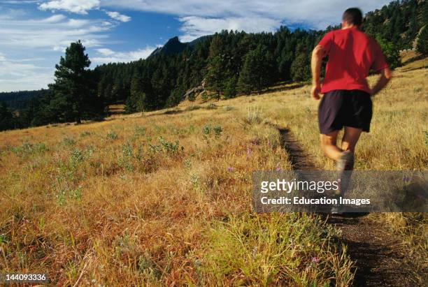 Colorado, Boulder, Man Running Flagstaff Mountain Trail.