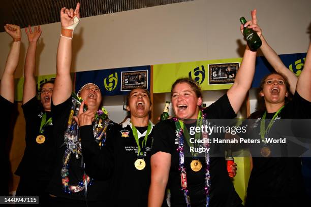 Charmaine McMenamin, Sarah Hirini, Luka Connor and Chelsea Bremner of the New Zealand Black Ferns celebrate in the dressing room after winning the...