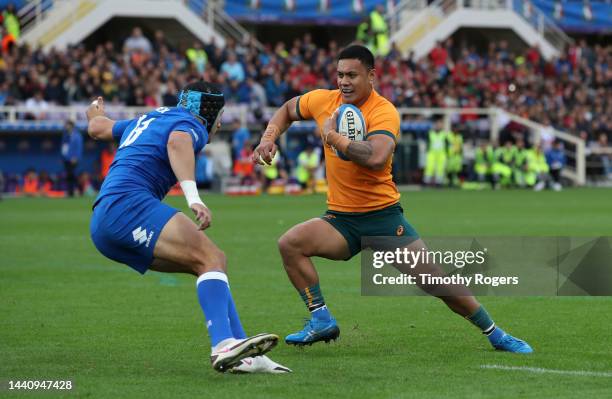 Len Ikitau of Australia runs at Ignacio Brex of Italy during the Autumn International match between Italy and Australia at Stadio Artemio Franchi on...