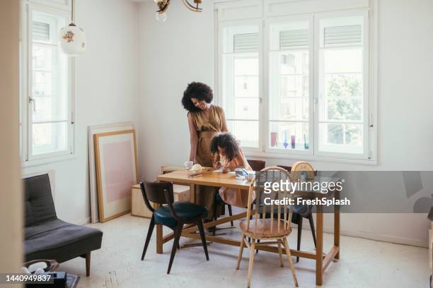 tutor helping little girl with homework - choicepix stock pictures, royalty-free photos & images