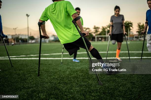 amputee soccer players playing with the ball on the soccer field - league all access stock pictures, royalty-free photos & images