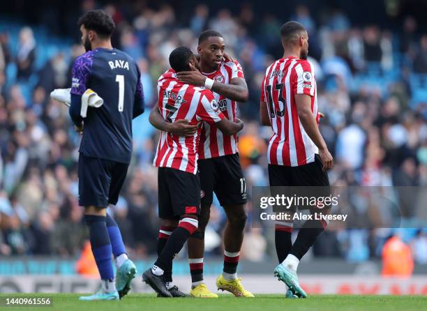 Ivan Toney and Rico Henry of Brentford celebrate after their sides victory during the Premier League match between Manchester City and Brentford FC...