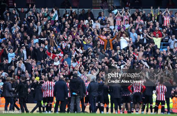 Brentford fans celebrates after their sides victory during the Premier League match between Manchester City and Brentford FC at Etihad Stadium on...