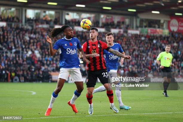 Alex Iwobi of Everton is challenged by Marcos Senesi of AFC Bournemouth during the Premier League match between AFC Bournemouth and Everton FC at...