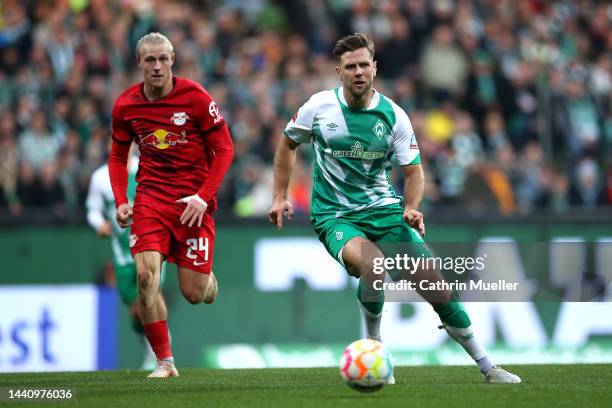 Niclas Fullkrug of SV Werder Bremen being followed by Xaver Schlager of RB Leipzig during the Bundesliga match between SV Werder Bremen and RB...