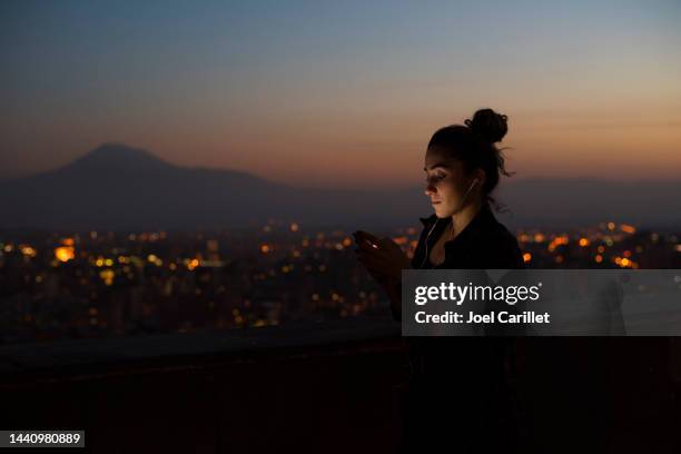 university student listening to music at dusk in yerevan, armenia - the capital of the armenian city stock pictures, royalty-free photos & images