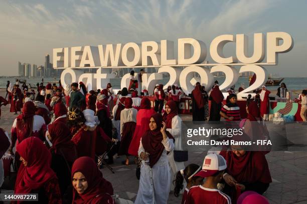 Members of the Ladies Mega Fans football supporters group gather at the Corniche next to the Fifa World Cup logo ahead of the FIFA World Cup Qatar...
