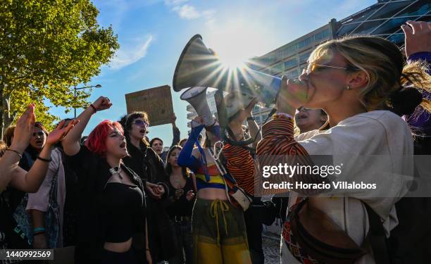 Demonstrators chant and hold placards at the rally convened by the Coalition "Unir contra o Fracasso Climático" , which brings together several...