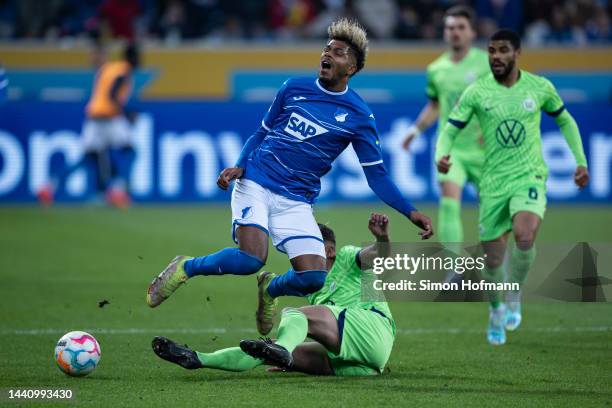 Georginio Rutter of Hoffenheim is tackled by Micky van de Ven of Wolfsburg during the Bundesliga match between TSG Hoffenheim and VfL Wolfsburg at...