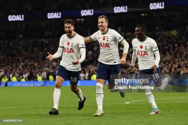 Rodrigo Bentancur celebrates with Harry Kane and Yves Bissouma of Tottenham Hotspur after scoring their team's fourth goal during the Premier League...