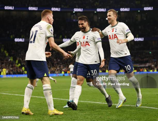 Rodrigo Bentancur celebrates with Harry Kane of Tottenham Hotspur after scoring their team's fourth goal during the Premier League match between...