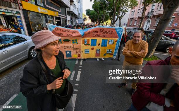 Demonstrators parade in front of a banner at the rally convened by the Coalition "Unir contra o Fracasso Climático" , which brings together several...