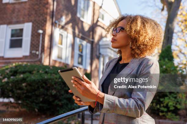 female real estate appraiser, examining the townhouse in queens, new york. - businesswoman nyc stock pictures, royalty-free photos & images