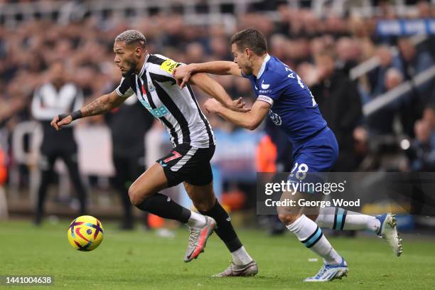 Joelinton of Newcastle United is challenged by Cesar Azpilicueta of Chelsea during the Premier League match between Newcastle United and Chelsea FC...