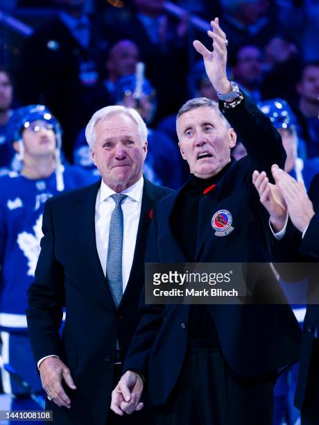 Hockey Hall of Fame member Borje Salming waves alongside Darryl Sittler before a ceremony ahead of the game between the Toronto Maple Leafs and the...