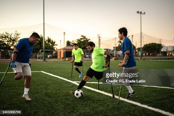amputee soccer players in a match on the soccer field - sunday league stock pictures, royalty-free photos & images