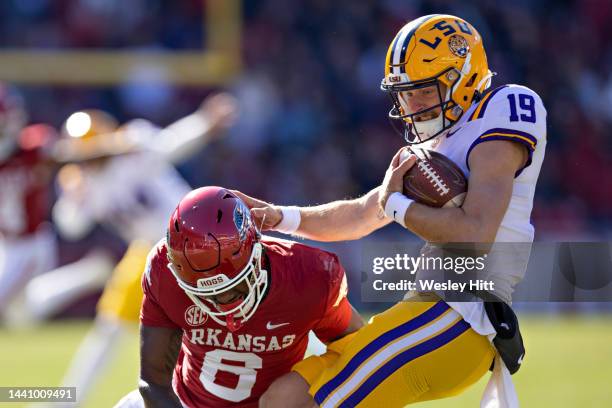 Jay Bramblett of the LSU Tigers attempts a fake punt in the first half and is tackled by Jacorrel Turner of the Arkansas Razorbacks at Donald W....