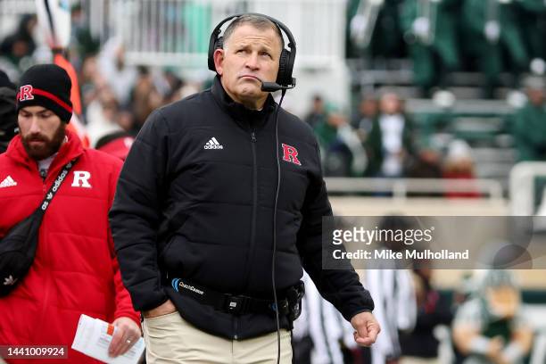 Greg Schiano coach of the Rutgers Scarlet Knights looks on in the first half of a game against the Michigan State Spartans at Spartan Stadium on...