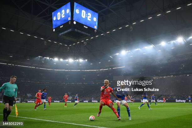 General view inside the stadium as Eric Maxim Choupo-Moting of Bayern Munich battles for possession with Henning Matriciani of FC Schalke 04 during...