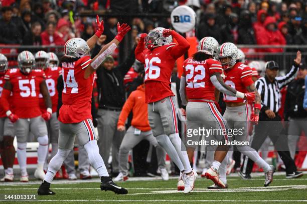 Tuimoloau and Cameron Brown of the Ohio State Buckeyes react after making a third down stop during the first quarter of a game against the Indiana...