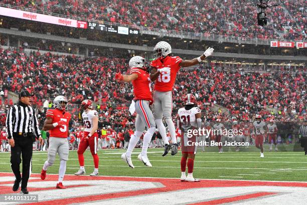 Marvin Harrison Jr. #18 of the Ohio State Buckeyes celebrates his first quarter touchdown with teammate Emeka Egbuka of the Ohio State Buckeyes...