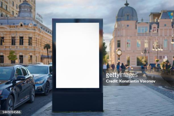 blank city format (lightposter, citylight) banner on the sidewalk mockup. pylon, a free-standing light box ready for your content - plakat mock up stock-fotos und bilder