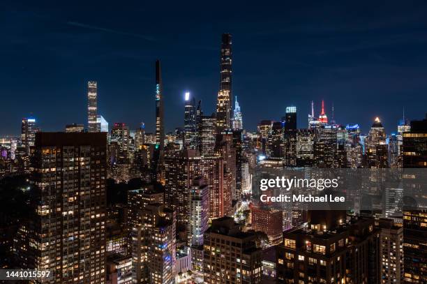 high angle night view of  billionaires' row and midtown manhattan - empire state building red stock pictures, royalty-free photos & images