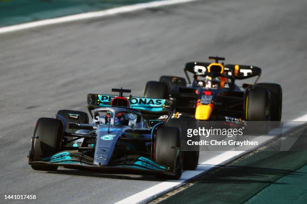 George Russell of Great Britain driving the Mercedes AMG Petronas F1 Team W13 leads Max Verstappen of the Netherlands driving the Oracle Red Bull...
