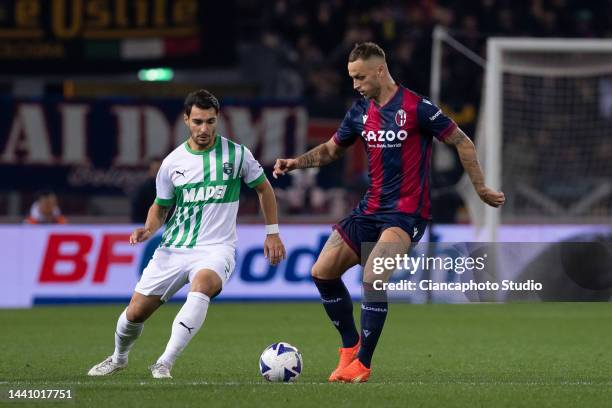 Marko Arnautovic of Bologna FC competes for the ball with Kaan Ayhan of US Sassuolo during the Serie A match between Bologna FC and US Sassuolo at...