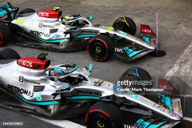 Sprint winner George Russell of Great Britain and Mercedes and Third placed Lewis Hamilton of Great Britain and Mercedes stop in parc ferme during...