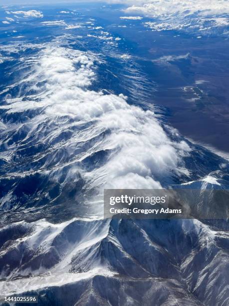 snowcapped rocky mountains viewed from above - stratosphere stock-fotos und bilder