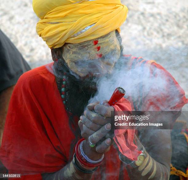 Indian Priest Sadhu Blowing Smoking Ganja Chillum Or Hashish.