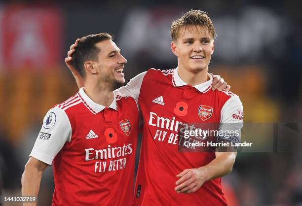 Cedric Soares and Martin Oedegaard of Arsenal celebrates following their side's victory in the Premier League match between Wolverhampton Wanderers...