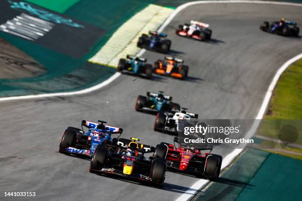 Sergio Perez of Mexico driving the Oracle Red Bull Racing RB18 leads a line of cars during the Sprint ahead of the F1 Grand Prix of Brazil at...