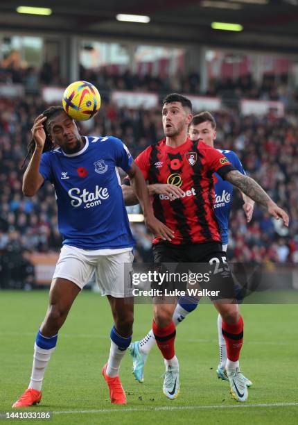 Alex Iwobi of Everton is challenged by Marcos Senesi of AFC Bournemouth during the Premier League match between AFC Bournemouth and Everton FC at...