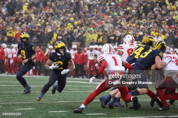 Blake Corum of the Michigan Wolverines runs for a first half touchdown behind Tyreke Johnson of the Nebraska Cornhuskers at Michigan Stadium on...