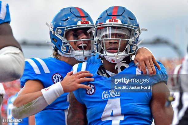 Quinshon Judkins of the Mississippi Rebels and Jaxson Dart of the Mississippi Rebels celebrate during the first half against the Alabama Crimson Tide...