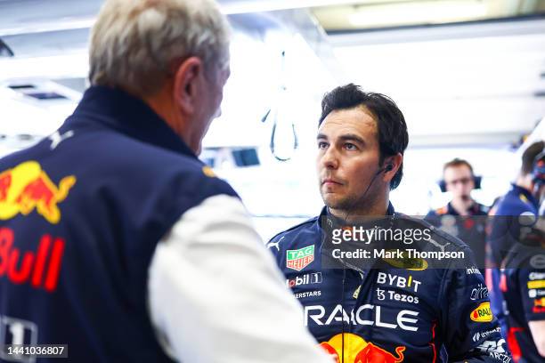 Sergio Perez of Mexico and Oracle Red Bull Racing talks with Red Bull Racing Team Consultant Dr Helmut Marko in the garage prior to the Sprint ahead...