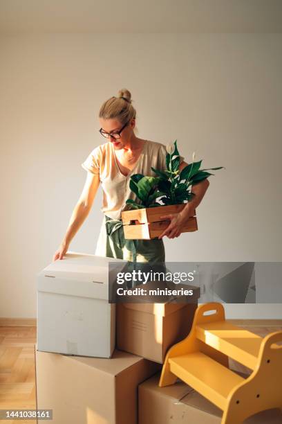 happy woman moving in new home - move to new place stock pictures, royalty-free photos & images