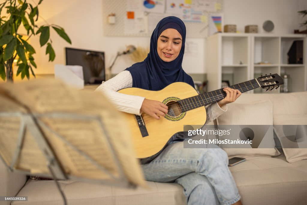 Arab Instruments Lady Playing Muslim Woman In Hijab Playing A Guitar At Home High-Res Stock Photo ...