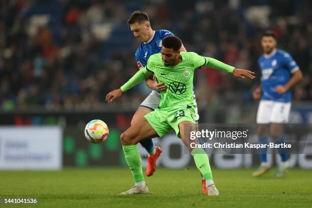 Felix Nmecha of VfL Wolfsburg is tackled by Angelo Stiller of TSG 1899 Hoffenheim during the Bundesliga match between TSG Hoffenheim and VfL...