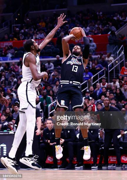 Paul George of the LA Clippers takes a shot against Kevin Durant of the Brooklyn Nets in the second half at Crypto.com Arena on November 12, 2022 in...