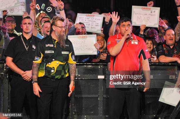 Simon Whitlock of Australia and Mensur Suljovic of Austria during the Cazoo Grand Slam of Darts group match at Aldersley Leisure Village on November...