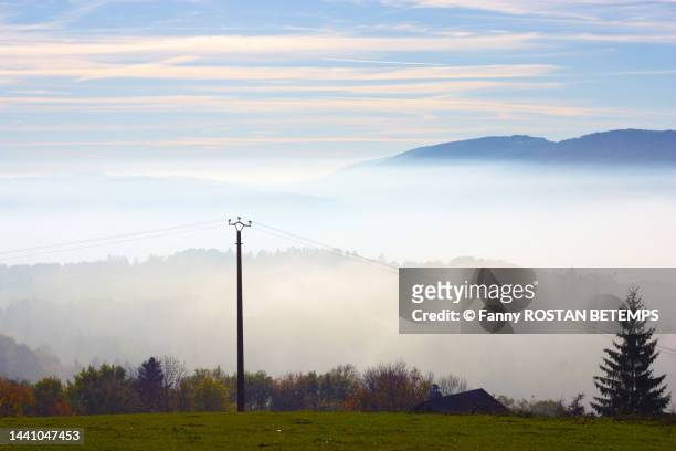 view of the salève mount of haute savoie from the top of the village of lucinges ( haute savoie , france ), bordered by a sea of ​​clouds - haute voltige stock pictures, royalty-free photos & images