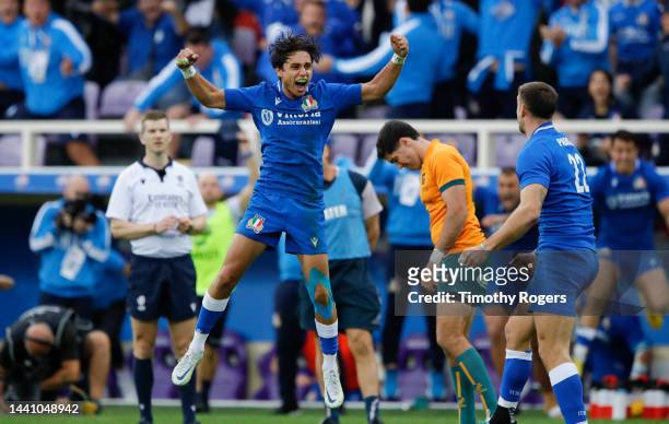 Ange Capuozzo of Italy celebrates as Ben Donaldson of Australia looks despondent at the end of the Autumn International match between Italy and...
