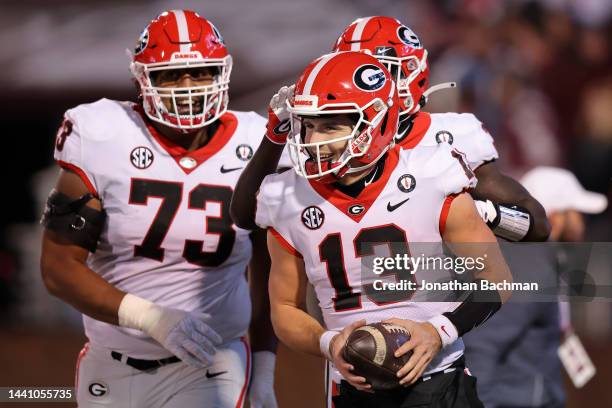 Stetson Bennett of the Georgia Bulldogs celebrates a touchdown during the first half of the game against the Mississippi State Bulldogs at Davis Wade...