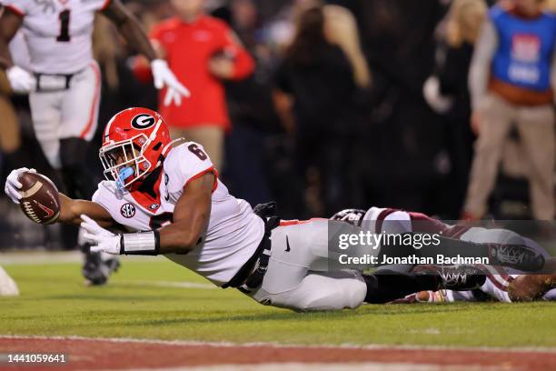 Kenny McIntosh of the Georgia Bulldogs dives for a first down as Shawn Preston Jr. #12 of the Mississippi State Bulldogs defends during the first...