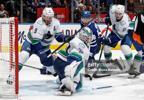 Miller, Spencer Martin and Ilya Mikheyev of the Vancouver Canucks defend against Michael Bunting of the Toronto Maple Leafs during the second period...